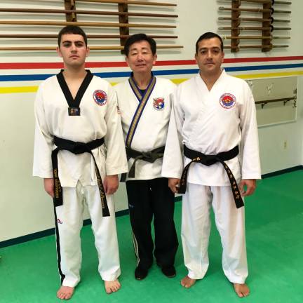 John Fernandez of Sparta achieved his Second Degree(2nd Dan) in Taekwondo. Alejandro Narvaez of Newton was promoted to First Degree Black Belt, Taekwondo. The men demonstrated their skill in Forms, Sparring, and Breaking on Saturday, December 2nd, at Kim's Martial Arts of Lafayette.In the photo from left to right are: John Fernandez, Grandmaster Ik Hwan Kim, and Alejandro Narvaez.