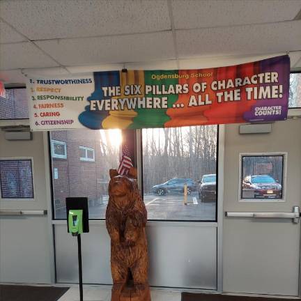 The Ogdensburg School mascot stands near the entrance.