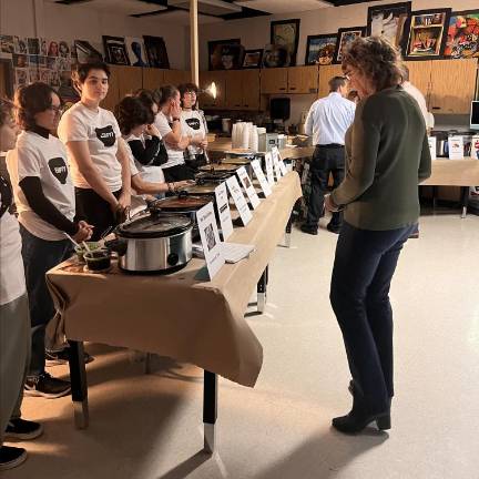 Students serve soup to science teacher Lauren Ayers.