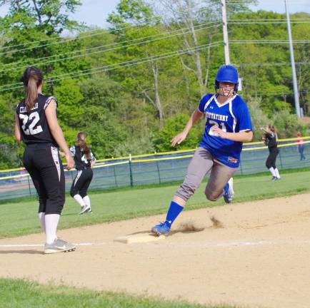 After the ball is hit into the outfield Kittatinny runner Kelly Insalaco rounds third base on the way to home plate to score in the sixth inning. Kittatinny Regional High School defeated Wallkill Valley Regional High School in varsity softball on Thursday, May 11, 2017. The final score was 3-1. The game took place at Kittatinny Regional High School in Hampton Township, New Jersey.