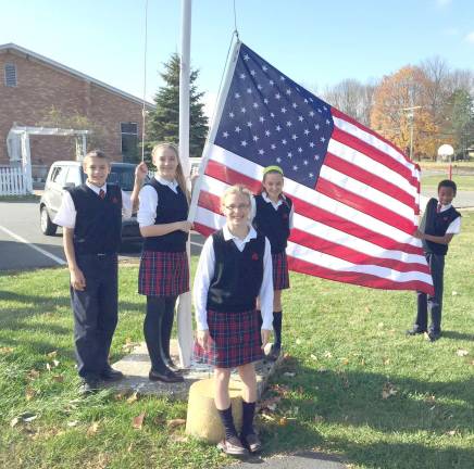 Reverend Brown Student Council members raised a new flag on Veterans Day.