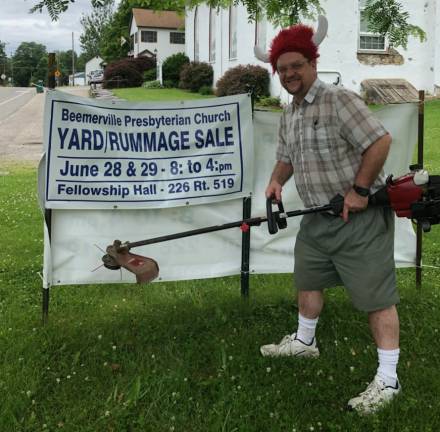 Pastor Barry Young found a matching ensemble: a red weed wacker and a red wacky Viking helmet at the Church Yard/ Rummage Sale.