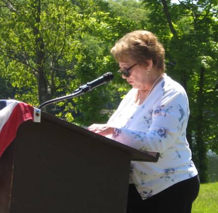 Senior Club President Joyce Healy asks the group to stand for the Pledge of Allegiance.