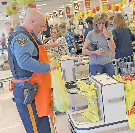 Patrolman Brendan Prol from the Franklin Borough Police Department takes time out of his busy day to assist customers with their groceries