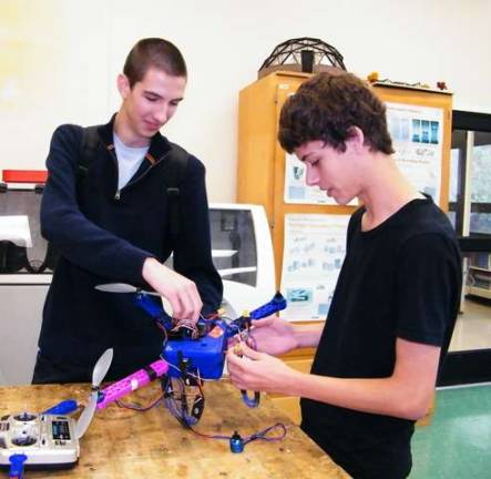 High Point High School seniors Corey Orlovsky, left, and Bob Burghart, right, are able to direct their quadcopter to fly anywhere in the world using a GPS attached to the machine.