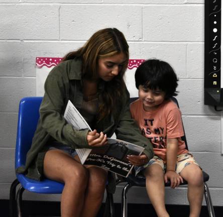 BK3 Senior Andrea Piedrasanta reads to preschool student Evan McCouch.