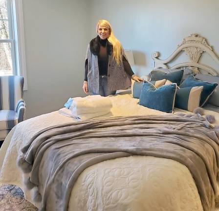 Interior Designer Nicola Jane Callaghan stands in one of beautiful rooms she helped design.