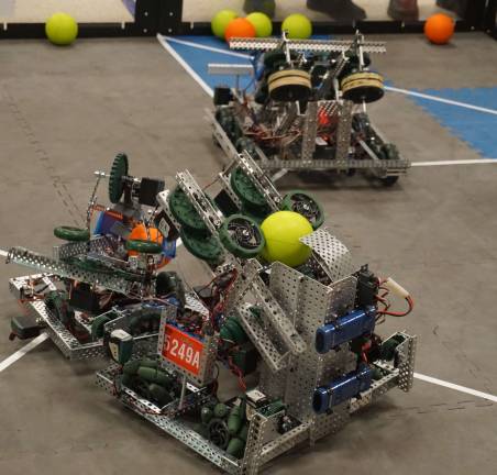Team E.L.K.'s robot, right, competes with another robot.