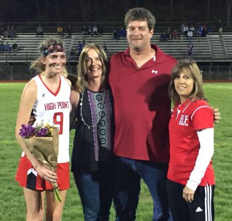 High Point's Emma Cawley, left, recently scored her 100th career goal in girls' lacrosse. Pictured with Emma are her parents, Eileen and Jerry Cawley (middle) , and Head Coach Joy Carter.
