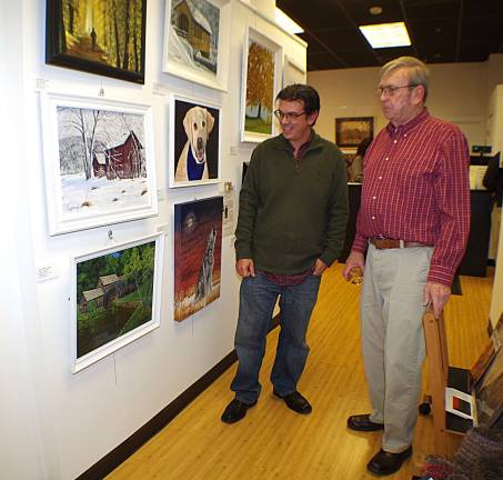 At left, gallery director John Maione Jr., a painter from Mountain Lakes, is shown with William Lungren, a self-taught West Milford artist who uses acrylic paints to capture the local imagery.