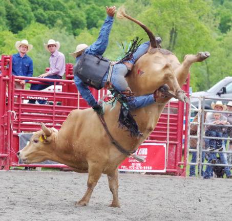 Green Valley Farm hosts rodeo Cowboy Austin Beaty of Bedford, Virginia keeps his grip as he rides a big snotty bull in the bull riding event.