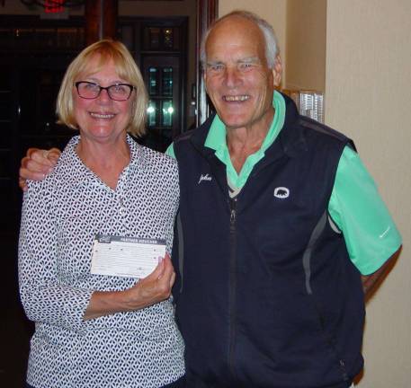 Closest to the pin winner Cathy Brennan accepts her prize from John Whiting
