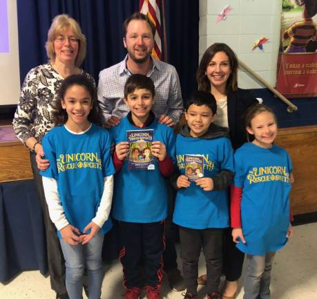 Pictured (front row l-r Sadie Biondo, Lorenzo Flores DeBenedictis, Patrick Maloney, Susan Skellenger, back row l-r Sue Ploch, Media Specialist, Author Adam Gidwitz, Jennifer Cimaglia, Principal).