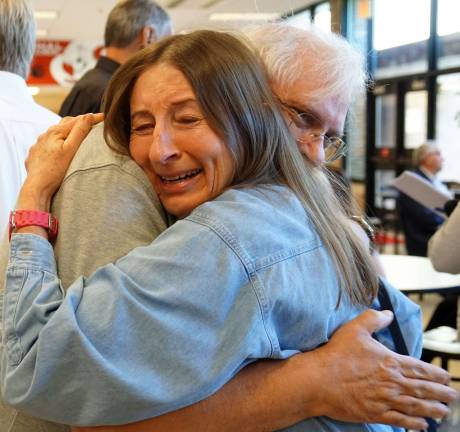 PHOTOS BY VERA OLINSKI From left, Kathy Sienko Keba hugs classmate Jack Card.