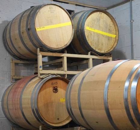 Enormous wooden wine barrels wait for long-term storage of red wine.