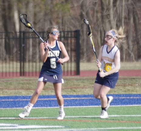 Roxbury's Olivia Serpa with the ball while covered by Jefferson's Melissa Webber.