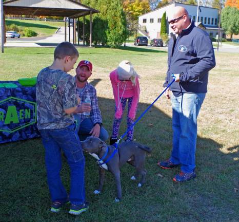 At right, Franklin Police Department Patrolman Rafael Burgos brought his six-month old blue nose terrier &#xfe;&#xc4;&#xfa;Diesel&#xfe;&#xc4;&#xf9; to interact with the children.