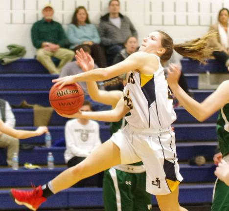 Jefferson's Victoria Pietraszkiewicz breaks through the Villa Walsh defense with the ball during a leaping shot.