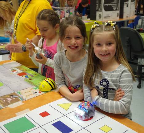 The show must go on Walnut Ridge students Emma Casper, 6, and Kaitlyn Hordych, 7, were all smiles as they tried out an educational board game.