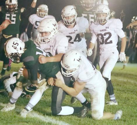 Sussex Tech ball carrier Josiah O'Connor is brought down by Wallkill Valley defenders in the second half.