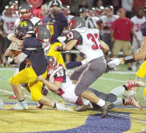 Jefferson ball carrier Michael Gould (26) is tackled by High Point defenders in the second half. Gould ran for 150 yards resulting in three touchdowns