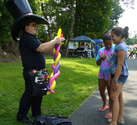 The Unstoppable and Mr. Unpoppable Mark Ghia makes a balloon for Bunje and Isabell of Hardyston Township.