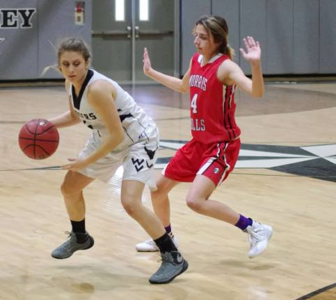 Wallkill Valley's Caitlyn Mizeski dribbles the ball while covered by Morris Hills Frankie Perna. Mizeski scored four points. Morris Hills High School (Rockaway, NJ) defeated Wallkill Valley Regional High School (Hamburg, NJ) in girls varsity basketball on Saturday, February 13, 2016. The final score was 46-20. The game took place at Wallkill Valley Regional High School.