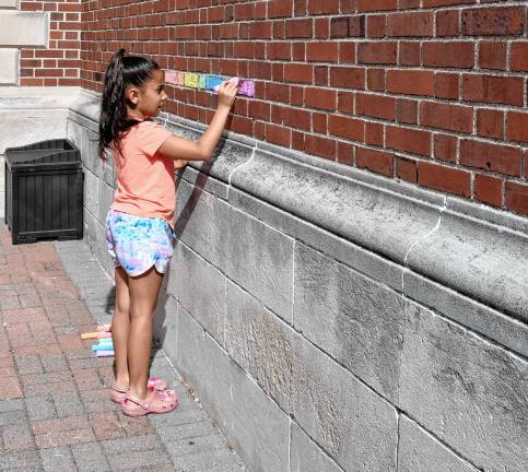 Photos: Chalk the Walk in Ogdensburg A girl colors bricks at Ogdensburg Elementary School on Monday, Sept. 1.