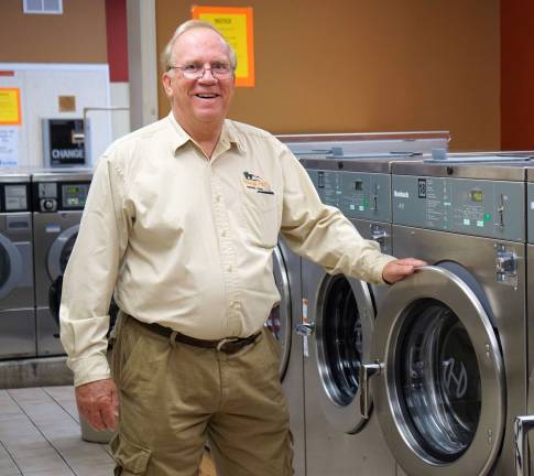 PHOTOS BY VERA OLINSKIGary Gardner stands with new machines in the Vernon Windy Hill Wash n' Dry.