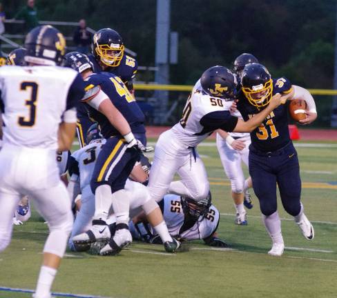 Jefferson linebacker Nicholas Miller grabs Vernon ball carrier Mike Stefkovich in the first quarter.