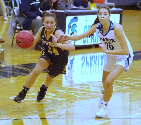 Jefferson's Mackenzie Rock on the move with the ball as Sparta's Alexa Acker tries to keep pace. Rock scored 10 points.