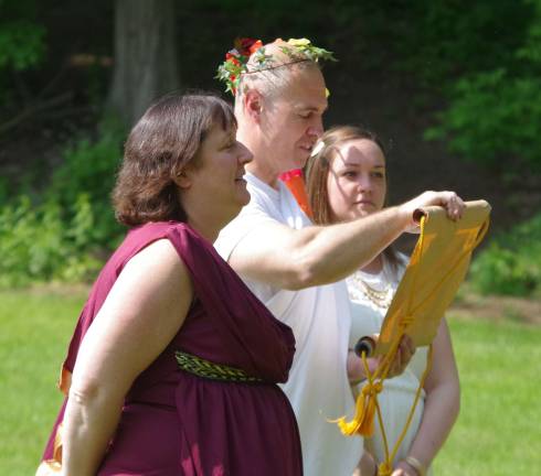 Declaring the start of the games are Hera, portrayed by Pam Dean, Zeus, portrayed by Michael Blochinger, and Aphrodite portrayed by Rachel Windish.