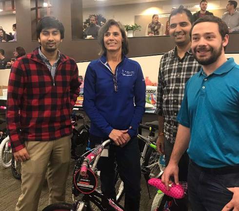 Assembly frenzy comes to Selective Andy Moulakis, Phani Povanki, Mindy Ooston and Tim Guppla proudly stand with the bike they assembled representing the Actuarial Department.