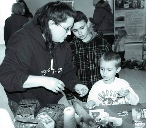 Photo by Nick Ortiz Member of the Friends of High Point work with Matthew Cary, 5 years old and Logan Nuss 9 years old resident of Wantage.