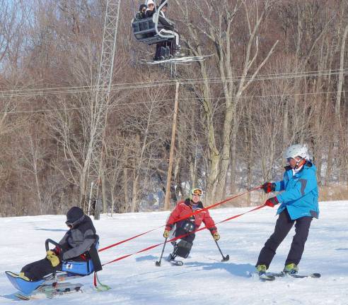 Adaptive Sports Program Trustee &amp; PSIA Trainer John Swartwood observes training with &#xfe;&#xc4;&#xfa;Sam&#xfe;&#xc4;&#xf9; on the Sugar Slope.