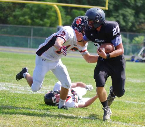 Wallkill Valley ball carrier Dylan Harlos on the run from Hackettstown defenders.