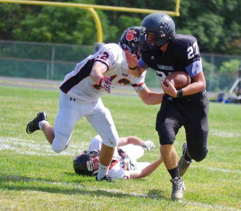 Hackettstown defeats Wallkill Valley, 41-7 Wallkill Valley ball carrier Dylan Harlos on the run from Hackettstown defenders.