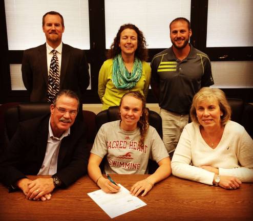 Sarah Hensal signs her letter of intent to swim for Division 1 Sacred Heart University in Fairfield, Conn. In front, Sarah Hensal is shown with her parents Carl and Gail Hensal. In back are: Principal John Tallmay, Guidance Counselor Beth Walton, Phys Ed. teacher Bill Cosentino