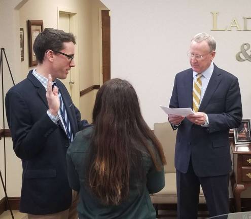 Son of firm's founder sworn in Ryan R. Laddey is sworn in by Thomas N. Ryan.