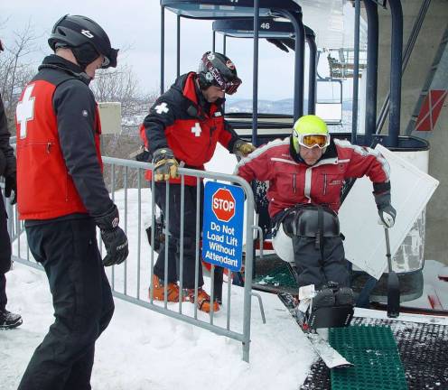 The PSIA adaptive instructor demonstrates how to exit the Cabriolet lift observed by Susanne Ebling and other ski patrollers.