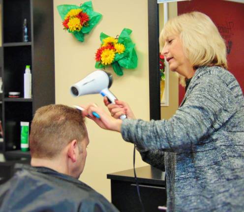 Veteran hairdresser opens salon Owner Linda Tribuzio cuts a clients hair.