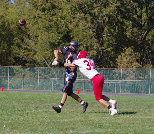 Wallkill Valley quarterback Preston Nicolai throws the ball with a Lenape Valley defender in his face. Nicolai passed for 145 yards resulting in two touchdowns.