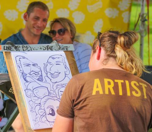 Good humor, anyone? A cartoonist draws a couple at the State Fair.