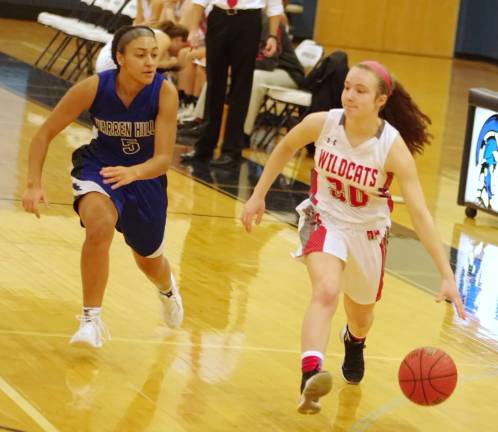 High Point's Noelle Gaffney dribbles the ball while being pursued by Warren Hills' Nicole Mallard in the first half. Gaffney grabbed two rebounds in the game.