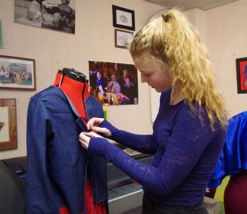 Stockholm resident Karleigh Noll, 16, works on one of the outfits for the 3rd Annual Veteran's Tribute and Fashion Show. Noll will be working as the stage manager for the third year in a row.