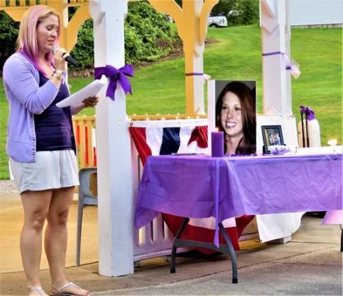 Vigil organizer Angela Lamendola speaks to those gathered at a candlelight vigil for Christine Solaro, 37, who was allegedly fatally shot by estranged husband Acting Newark Police Lt. John Formisano July 14.