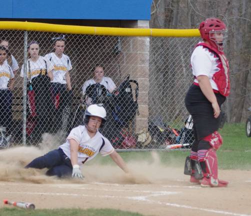 Jefferson's Amanda Delfino slides onto home plate in the first inning for a score.