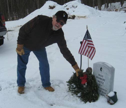 Wreath removal organizer Bill Gardner gets the job done on January 20.