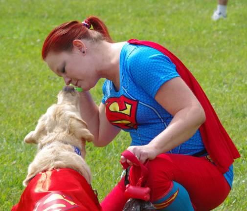 Doing it for the critters Visiting from Westtown, N.Y., Lynn Rhinesmith and her yellow lab Brodie wore "super" costumes and then competed in the Pucker-up contest.
