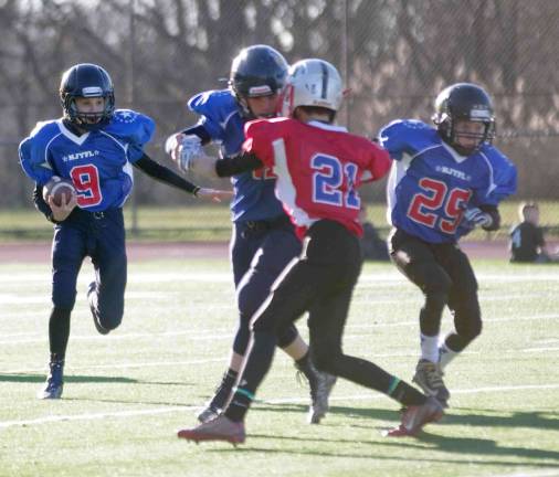 Blue All-Stars running back Max Schelle with the ball in the PeeWee game. Schelle plays for the Vernon Vikings.